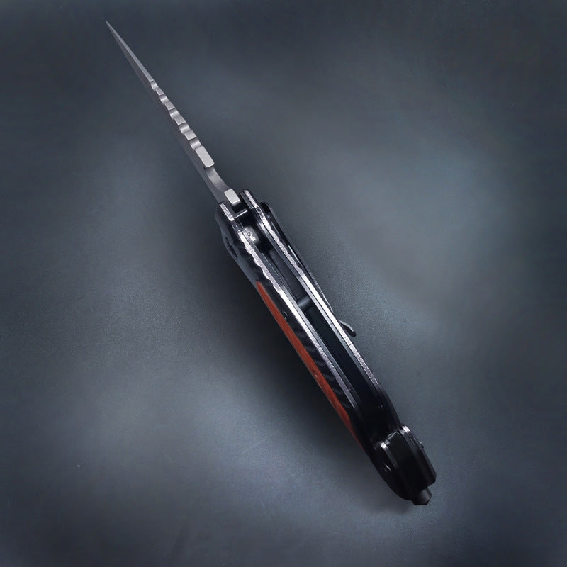 Closed folding knife side profile showing pocket clip on dark background