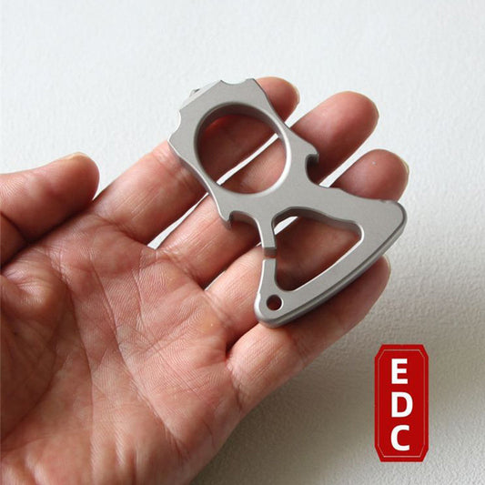Hand holding the stainless steel single-hole bottle opener knuckle duster with EDC label visible.
