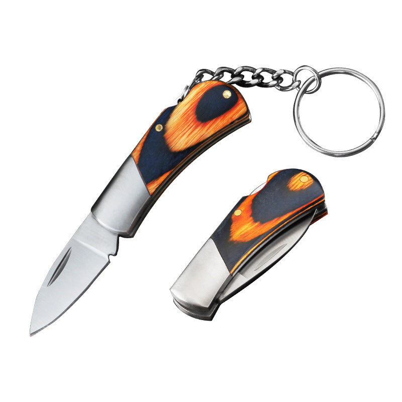 An open and a closed mini folding keychain knife photographed on a white background, both with navy-and-orange wood handles, silver bolsters, the open one showing its polished blade and the closed one its folded profile.