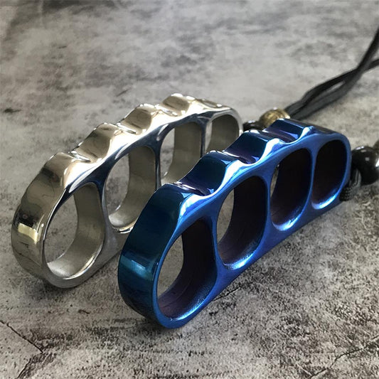 Close angled view of the silver and blue knuckle dusters showing the stepped bead-like edge and four finger holes