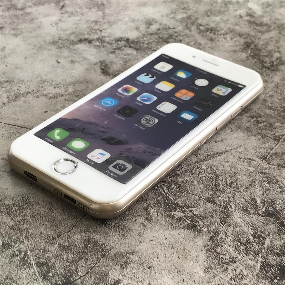 Close angled view of the gold phone-shaped device showing the printed app-icon face and the micro-USB port beside the ON and OFF switch