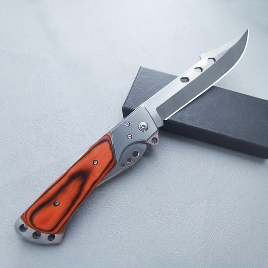 Large redwood handle folding knife partially open showing blade and silver frame