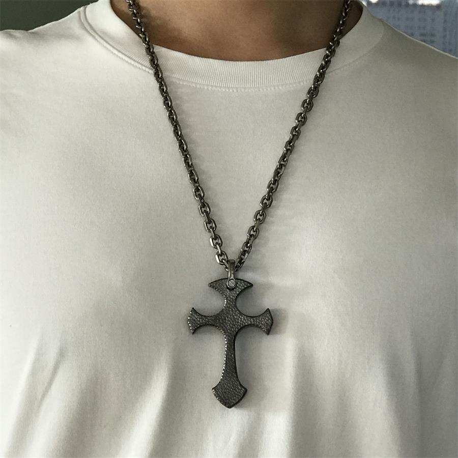Person wearing TC21 titanium cross necklace with white t-shirt showing fit and scale