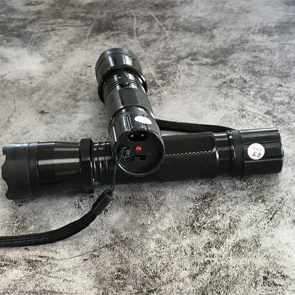 Close-up of charging port and power switch on black 1101 flashlight stun gun