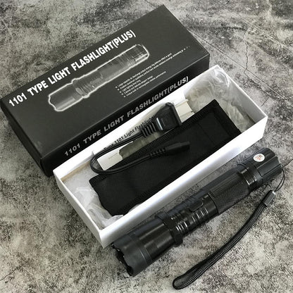 Black 1101 flashlight stun gun inside open retail box with charger and carrying pouch