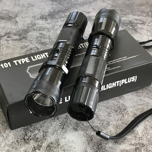 Two black 1101 flashlight stun guns on product box, side by side showing textured grip and wrist strap