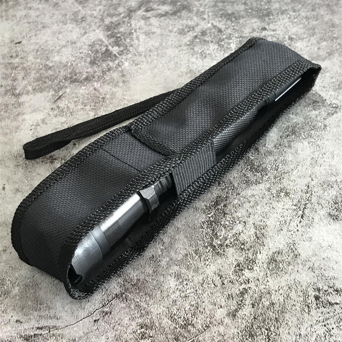 Black 1101 flashlight stun gun partially inserted in nylon holster with belt loop