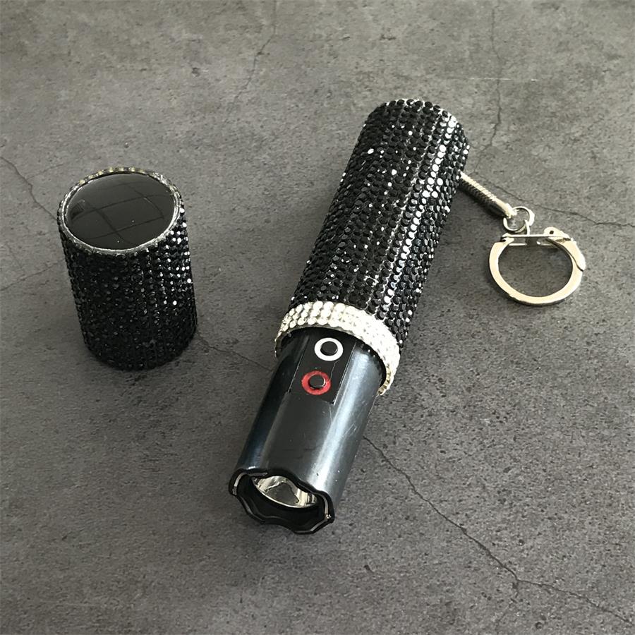 Black rhinestone-covered mini stun gun with cap removed showing LED head and keychain