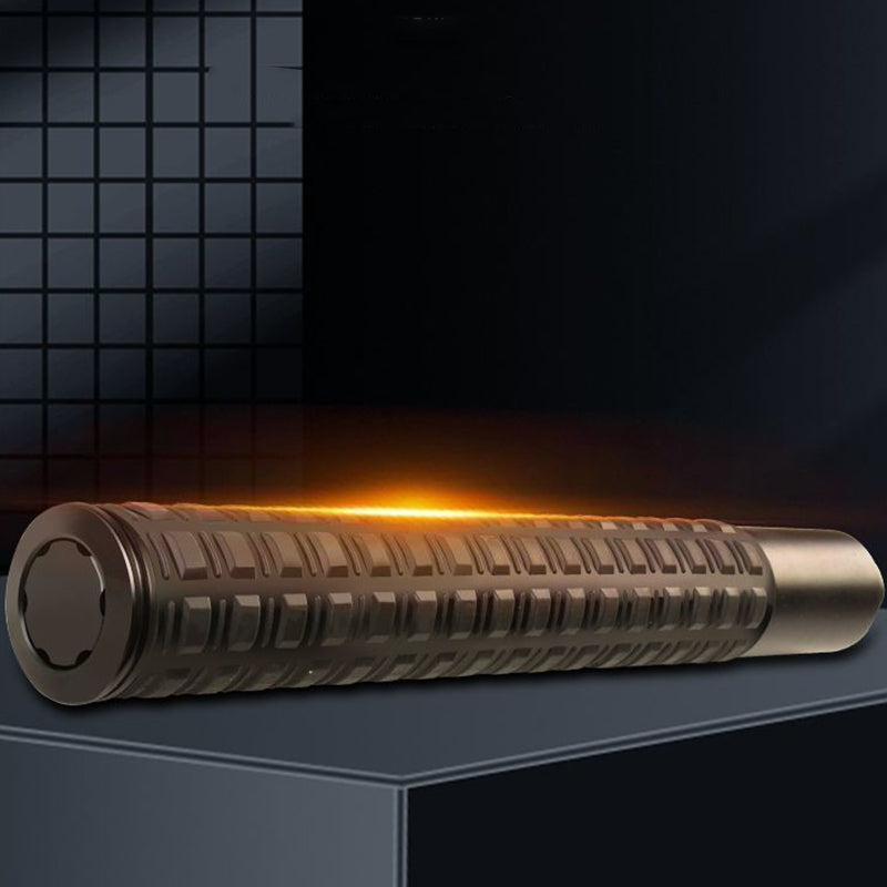 Collapsed tactical baton with grid grip glowing orange on dark display surface