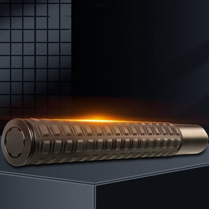 Collapsed tactical baton with grid grip glowing orange on dark display surface