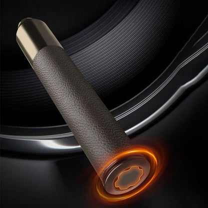 Close-up of baton leather grip with glowing orange window breaker tip detail