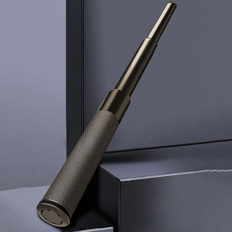 Extended baton with leather-textured handle leaning against dark geometric backdrop