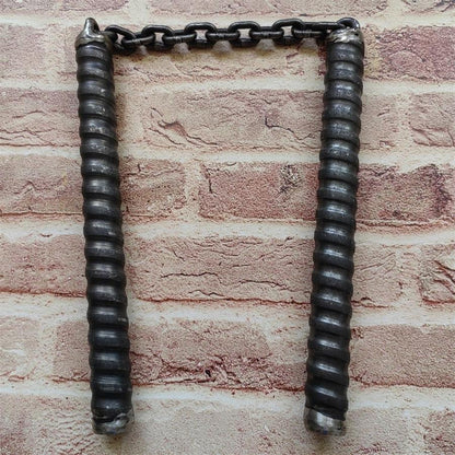 Two black rubber-gripped chain baton handles hanging side by side from metal chain