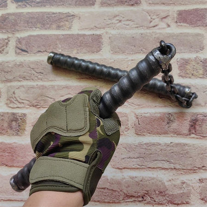 Gloved hand lifting one black chain baton handle with second handle and chain in background