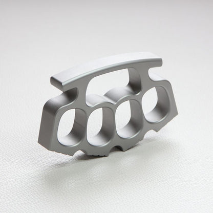 Silver knuckle duster standing upright on white background, palm-side view.