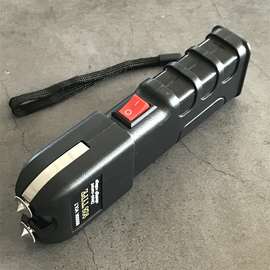Single black 928 device front angle showing red switch and wrist lanyard