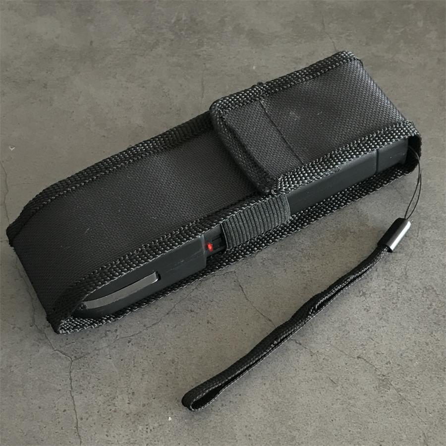 Black 928 device inserted in black nylon holster with lanyard