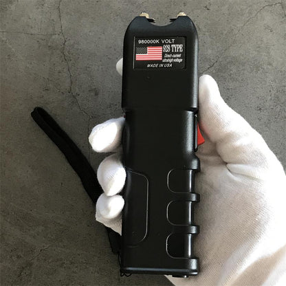 980000K 928 device held in a gloved hand showing textured grip