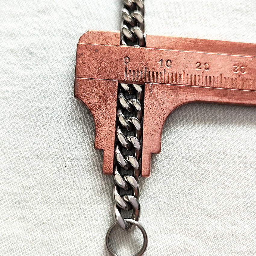 Copper caliper measuring the width of the pure titanium chain link.