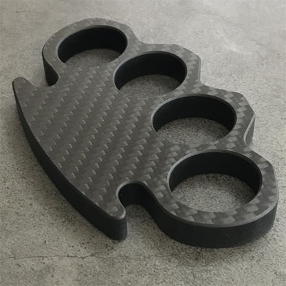 Classic Carbon Fiber Knuckle Duster on textured table