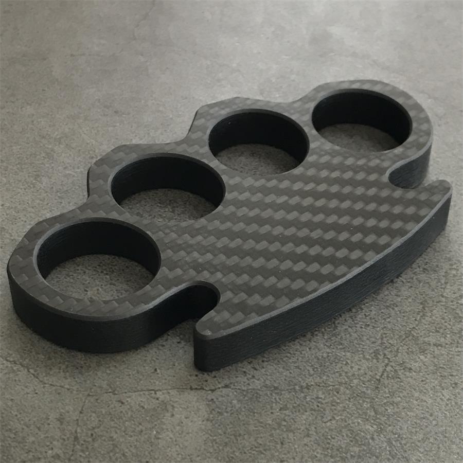 Classic Carbon Fiber Knuckle Duster on grey surface