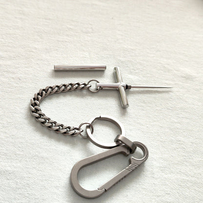 Complete EDC set: 304 steel cross toothpick, protective cap, titanium chain, split rings, and titanium carabiner.
