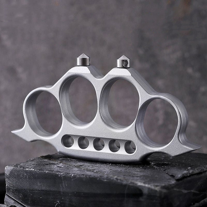 Zinc alloy knuckle duster displayed flat on stone