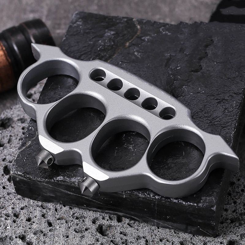 Creative zinc alloy knuckle duster on textured surface