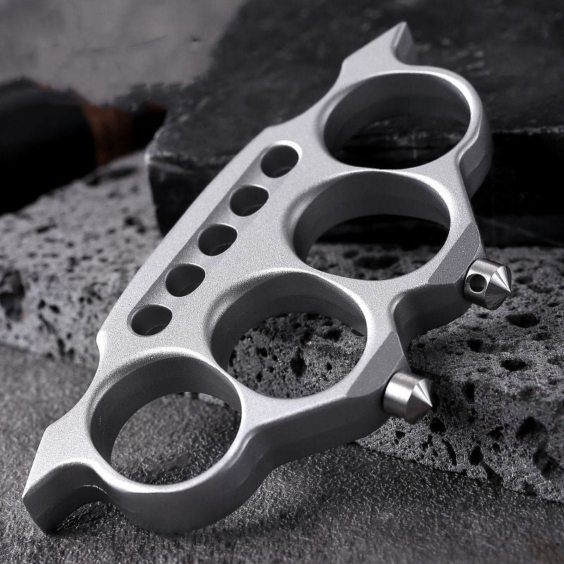 Zinc alloy knuckle duster placed on stone surface