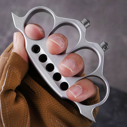 Gloved hand showing side of zinc alloy knuckle duster