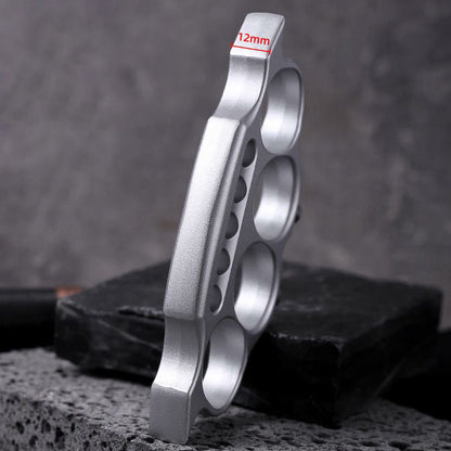 Zinc alloy knuckle duster standing upright on wood