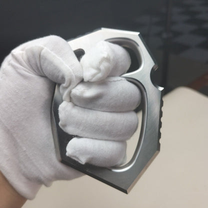 White-gloved fist gripping the two-finger rope hole duster, showing in-hand fit.