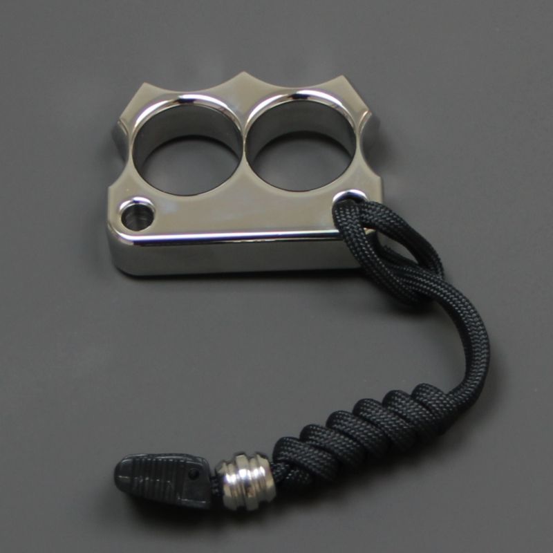 Front view of the mirror polished 316 steel two-hole mini duster with the black paracord lanyard attached.