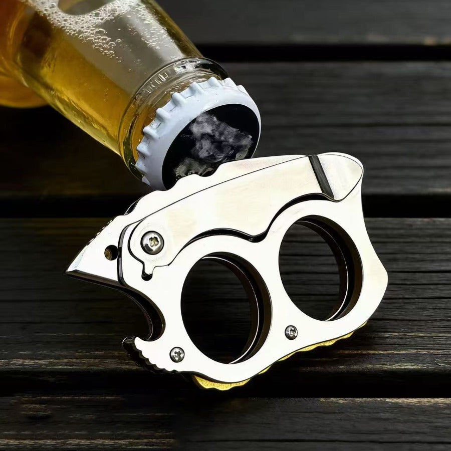 Mini Knuckle Knife beside beer bottle on wood