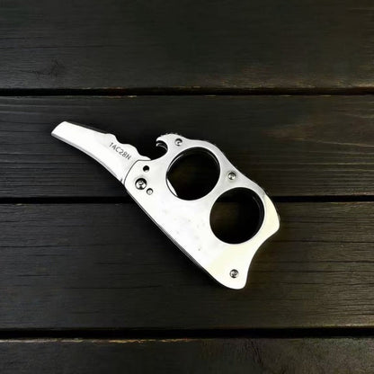 Mini Knuckle Knife lying flat on wood table	
