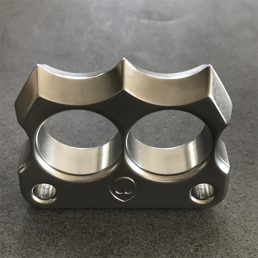 Mini 316 Steel Alien Knuckle Duster upright on stone