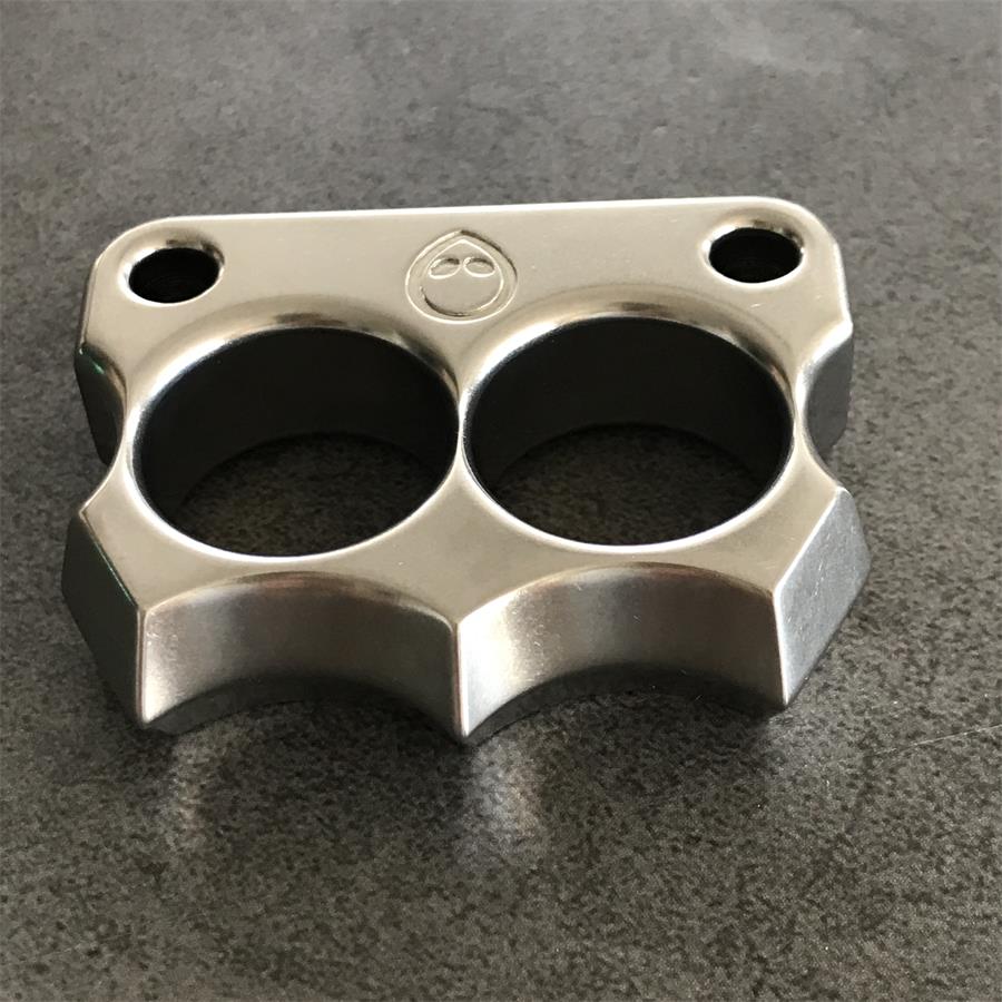 Mini 316 Steel Alien Knuckle Duster resting stone