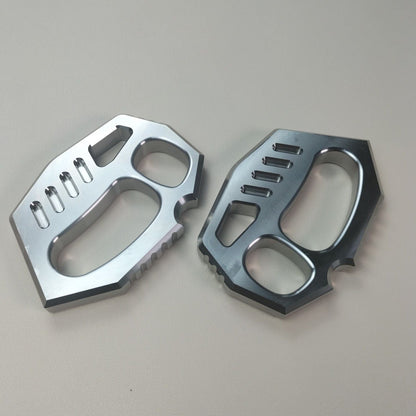 Two mirror polished two-finger rope hole dusters placed side by side on a light surface.