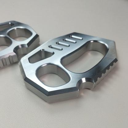 Angled flat lay of the two-finger rope hole duster highlighting the serrated edge and polished finish.