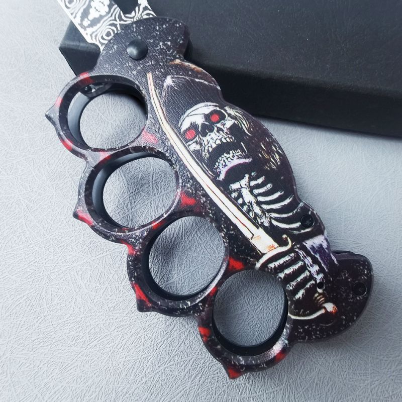 Folding EDC knife laid beside a scale reference