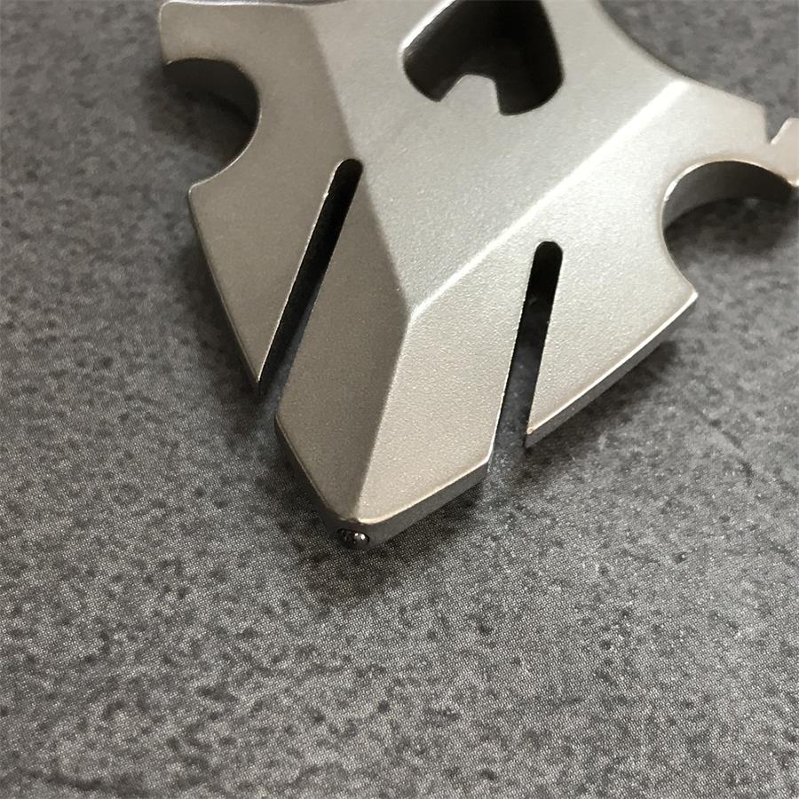 Hand holding TC21 titanium knuckle duster flat