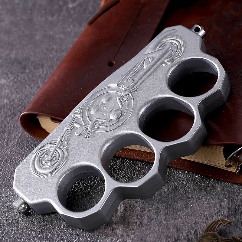 Gloved hand displays zinc alloy knuckle duster