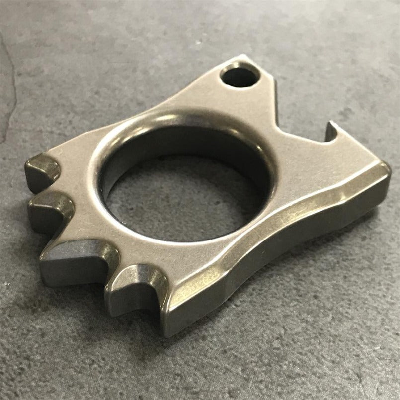 Hedgehog Knuckle Duster laid sideways on dark stone