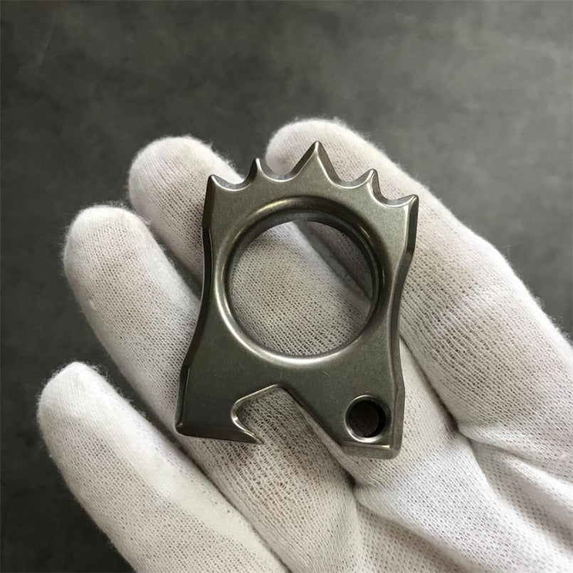 White glove carefully holding the Titanium Knuckle Duster