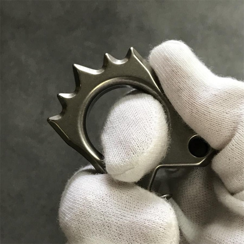 Gloved finger passed through Hedgehog Knuckle Duster ring