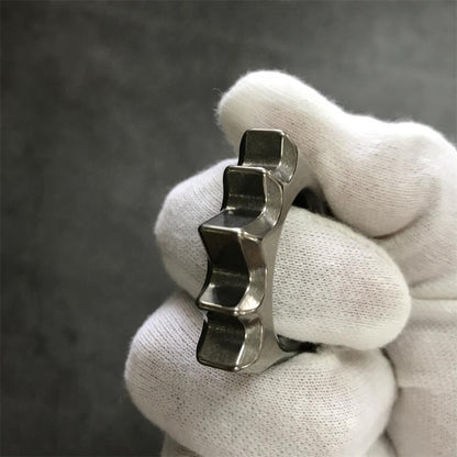 White glove gripping the Titanium Hedgehog Knuckle Duster