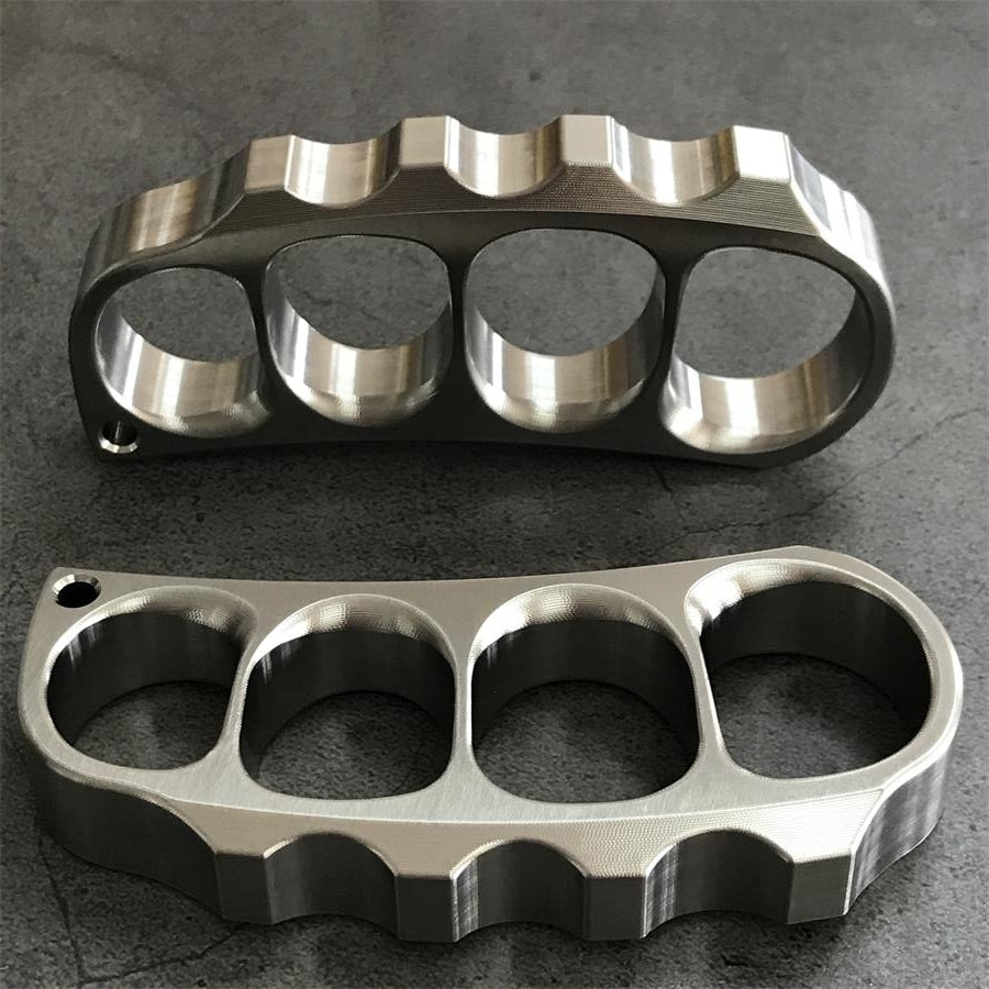 Two titanium knuckle dusters placed vertically