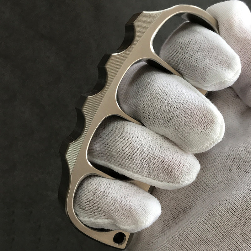 Holding titanium knuckle duster facing front