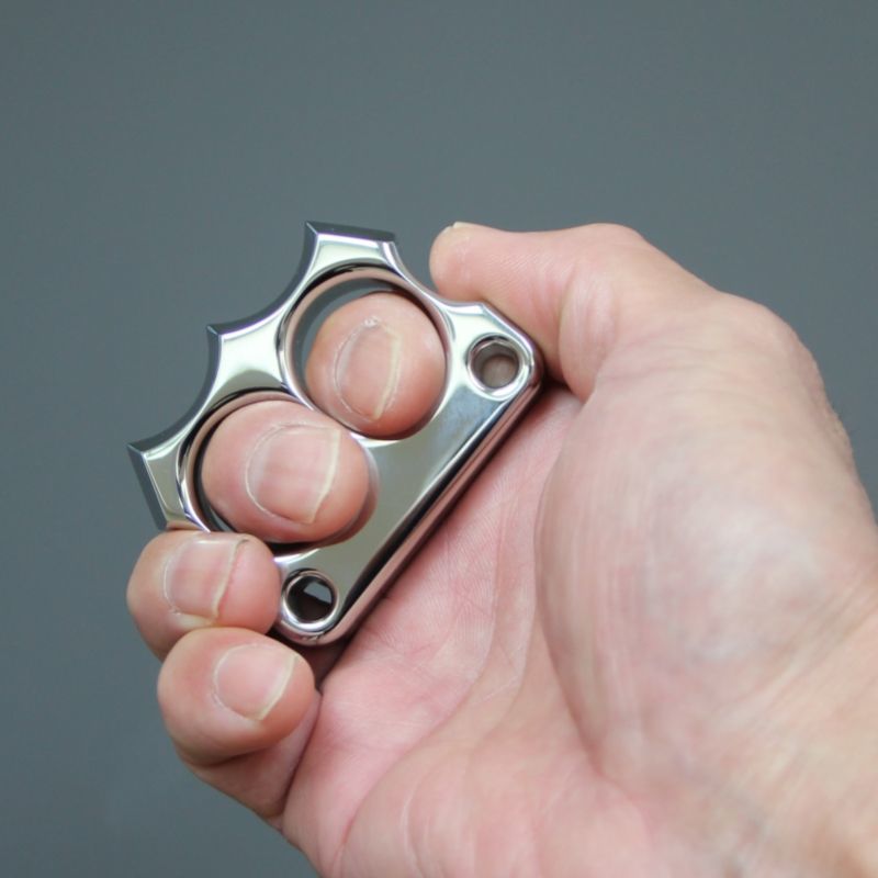 Hand gripping the mirror polished 316 steel two-hole mini duster, showing two-finger fit.