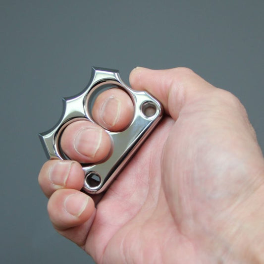 Hand gripping the mirror polished 316 steel two-hole mini duster, showing two-finger fit.